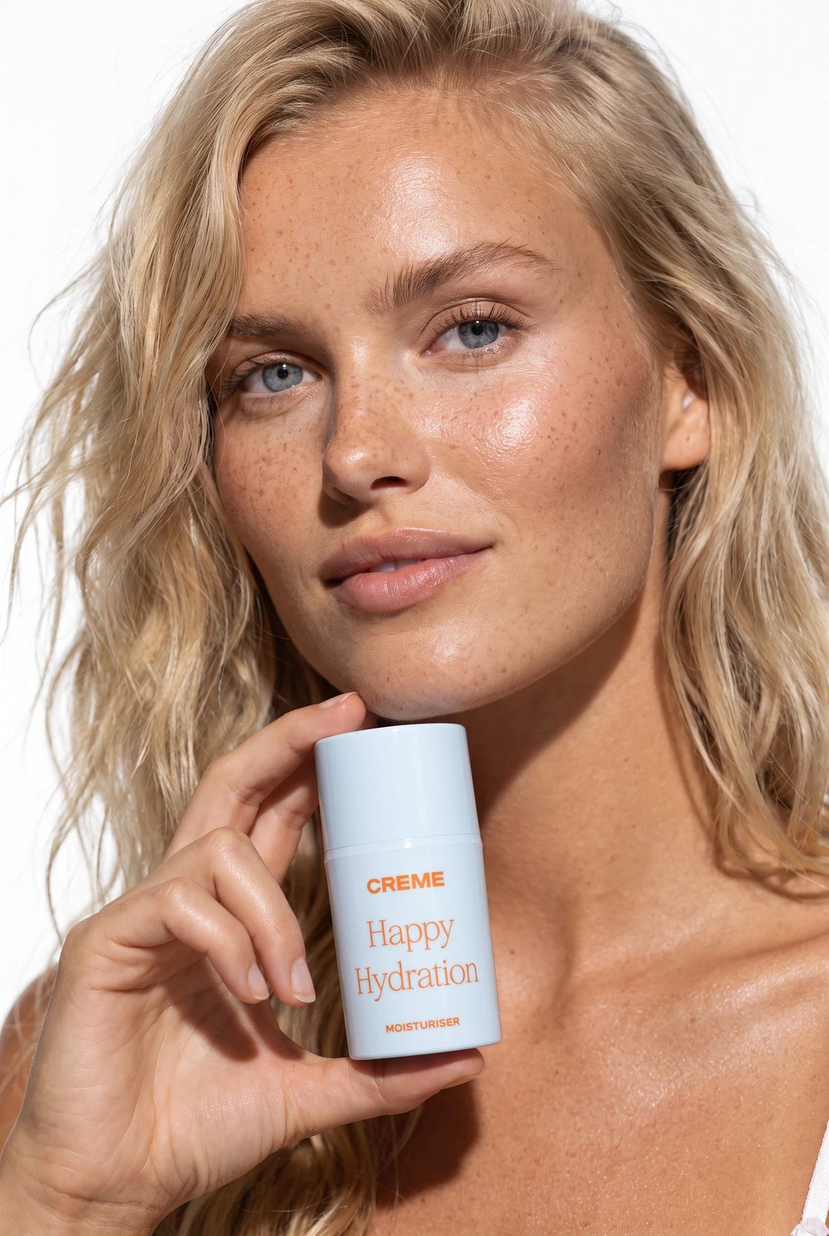 Model holding Happy Hydration moisturiser